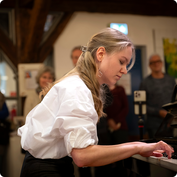 Wide shot of pianist performing on concert stage